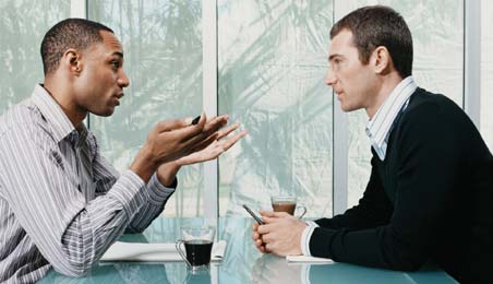 Two men sitting on a conversation