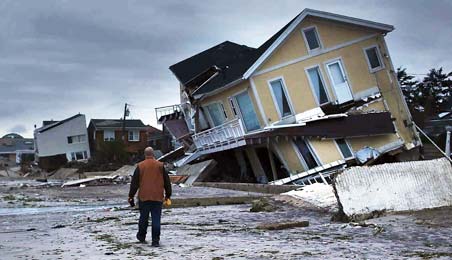 A man witnessing his home destroyed in Hurricane Sandy